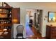Hallway view shows a hardwood floor, a desk with bookcase, and decorative mirror at 8 Greenside Ct, Durham, NC 27707