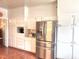 Bright kitchen with stainless steel appliances, white cabinetry, and tiled floors at 8 Greenside Ct, Durham, NC 27707