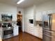 Bright kitchen with stainless steel appliances, white cabinetry, and tiled floors at 8 Greenside Ct, Durham, NC 27707