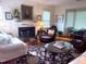 Cozy living room featuring a fireplace, hardwood floors, and comfortable seating at 8 Greenside Ct, Durham, NC 27707