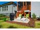 Backyard patio with outdoor seating, grill, and landscaping at 83 Vandalia Ave, Chapel Hill, NC 27516