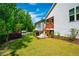 Spacious backyard with a green lawn, privacy fence, and lush landscaping at 83 Vandalia Ave, Chapel Hill, NC 27516
