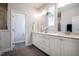 Bathroom featuring double sinks, vanity, mirrors and walk in shower at 83 Vandalia Ave, Chapel Hill, NC 27516