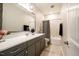 Bright bathroom with a vanity, large mirror, shower, and tub at 83 Vandalia Ave, Chapel Hill, NC 27516
