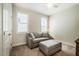 Bedroom with ceiling fan, carpet, and a comfy sofa and ottoman at 83 Vandalia Ave, Chapel Hill, NC 27516