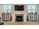 Modern fireplace with a sleek design, flanked by custom cabinets for stylish storage and decor at 83 Vandalia Ave, Chapel Hill, NC 27516