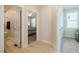 Hallway features light-wood floors, with views into bathroom on the left and bedroom on the right at 83 Vandalia Ave, Chapel Hill, NC 27516