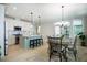 Modern kitchen with stainless steel appliances, center island with seating, and an adjacent dining area at 83 Vandalia Ave, Chapel Hill, NC 27516