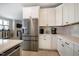 Bright kitchen featuring white cabinets, stainless steel appliances, and view of Gathering room at 83 Vandalia Ave, Chapel Hill, NC 27516