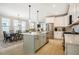 Open kitchen featuring white cabinets, stainless steel appliances, a kitchen island and dining area at 83 Vandalia Ave, Chapel Hill, NC 27516