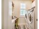 Clean laundry room with washer, dryer, utility sink and shelving at 83 Vandalia Ave, Chapel Hill, NC 27516