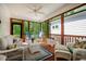 Charming screened-in porch with comfortable wicker furniture and wooded views at 83 Vandalia Ave, Chapel Hill, NC 27516