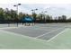 Well-maintained tennis court with a shaded bench area, offering a great place for recreation at 83 Vandalia Ave, Chapel Hill, NC 27516