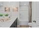 Clean bathroom with double sinks, dark cabinets, and a shower-tub combination with a curtain at 906 Kensley Grove Ln # 68, Fuquay Varina, NC 27526