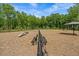 Community dog park offering open space, benches, and play features with wood chip ground cover and shade at 906 Kensley Grove Ln # 68, Fuquay Varina, NC 27526