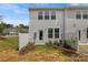 Rear exterior showcasing a two-story house with a fenced-in backyard and landscaping at 906 Kensley Grove Ln # 68, Fuquay Varina, NC 27526
