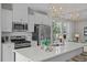 Modern kitchen featuring stainless steel appliances, white cabinets, and island seating at 906 Kensley Grove Ln # 68, Fuquay Varina, NC 27526