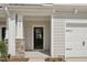 Inviting front entrance with black door, stone accents, and covered porch, leading to a well-maintained home at 908 Kensley Grove Ln # 68, Fuquay Varina, NC 27526