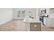 Bright, open kitchen with stainless steel appliances, white cabinets, quartz countertops, and wood floors at 908 Kensley Grove Ln # 68, Fuquay Varina, NC 27526