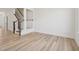 Inviting living room with wood floors and staircase, creating a warm and welcoming atmosphere at 908 Kensley Grove Ln # 68, Fuquay Varina, NC 27526