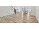 Open-concept living space showcasing hardwood floors, staircase, and a modern kitchen island at 908 Kensley Grove Ln # 68, Fuquay Varina, NC 27526