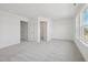 Large carpeted primary bedroom with natural light, walk-in closet, and neutral tones at 908 Kensley Grove Ln # 68, Fuquay Varina, NC 27526