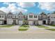 Street view of new construction townhomes with individual garages and landscaped front yards at 908 Kensley Grove Ln # 68, Fuquay Varina, NC 27526