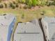 Aerial view of roof surrounded by green trees and neighboring homes at 10 Currituck Ln, Durham, NC 27703