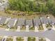 An aerial view showcases homes along a street, surrounded by lush green trees and landscaping at 10 Currituck Ln, Durham, NC 27703
