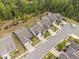 An aerial view showcases homes along a street, surrounded by lush green trees and landscaping at 10 Currituck Ln, Durham, NC 27703