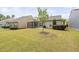 A well-maintained backyard features a lawn, screened porch, patio, and barbecue grill at 10 Currituck Ln, Durham, NC 27703