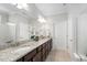 Bathroom with double vanity, granite countertop, and large mirror at 10 Currituck Ln, Durham, NC 27703