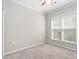 A bright bedroom with carpeted floors and a ceiling fan at 10 Currituck Ln, Durham, NC 27703