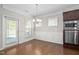 Dining area features wainscotting, a modern chandelier, and stainless steel appliances at 10 Currituck Ln, Durham, NC 27703