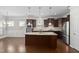Open kitchen layout with stainless steel appliances, granite countertops, and pendant lighting at 10 Currituck Ln, Durham, NC 27703