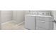 Laundry area featuring tiled floor, white walls, and a new white washer and dryer set at 10 Currituck Ln, Durham, NC 27703
