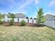 Spacious backyard with a white fence, green lawn, and landscaping offering privacy and beauty at 1002 Dogwood Bloom Ln, Knightdale, NC 27545