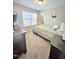 Cozy bedroom featuring neutral walls, plush carpeting, and a window for ample natural light at 1002 Dogwood Bloom Ln, Knightdale, NC 27545