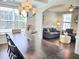 Dining room with hardwood floors, large table and a view into the beautifully staged living room at 1002 Dogwood Bloom Ln, Knightdale, NC 27545