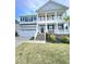 Beautiful two-story home featuring a welcoming porch, attached garage, and a well maintained yard at 1002 Dogwood Bloom Ln, Knightdale, NC 27545