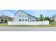Light blue two-story home with a white fence under a partly cloudy sky at 1002 Dogwood Bloom Ln, Knightdale, NC 27545