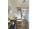 Elegant foyer with hardwood floors, staircase, console table and stylish decorative mirror at 1002 Dogwood Bloom Ln, Knightdale, NC 27545