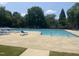 Large community swimming pool with lounge chairs and clear, inviting water for residents' enjoyment at 1002 Dogwood Bloom Ln, Knightdale, NC 27545