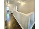 Hallway with hardwood flooring and a view into the adjacent bedrooms at 1002 Dogwood Bloom Ln, Knightdale, NC 27545