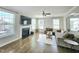 Bright living room featuring a fireplace, hardwood floors, and large comfortable sectional sofa at 1002 Dogwood Bloom Ln, Knightdale, NC 27545