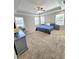 Bright and spacious primary bedroom with a tray ceiling, plush carpet, and an ensuite bathroom at 1002 Dogwood Bloom Ln, Knightdale, NC 27545