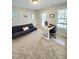 Inviting office space featuring a futon, desk, and natural light from two windows at 1002 Dogwood Bloom Ln, Knightdale, NC 27545