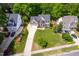 Spacious two-story home with a large lawn and long drive, surrounded by lush trees in a tranquil neighborhood at 1003 Fairfax Woods Dr, Apex, NC 27502