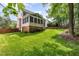 Expansive backyard featuring a screened-in porch and lush green lawn at 1003 Fairfax Woods Dr, Apex, NC 27502