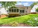 Well-maintained backyard showing a screen porch with an expansive lawn at 1003 Fairfax Woods Dr, Apex, NC 27502